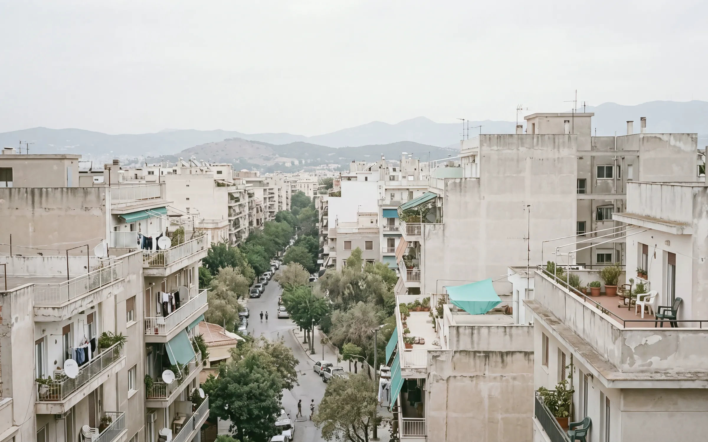 AI-generated scene: a Mediterranean city district seen from a rooftop on an overcast morning.