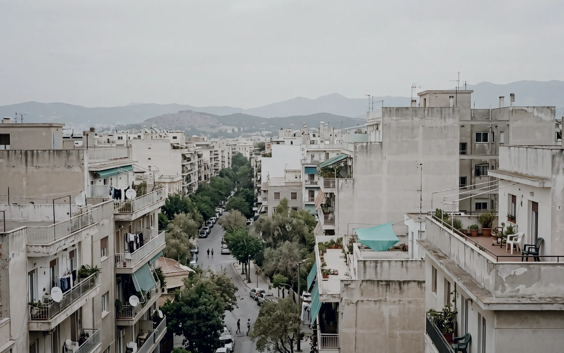 AI-generated scene: a Mediterranean city district seen from a rooftop on an overcast morning.